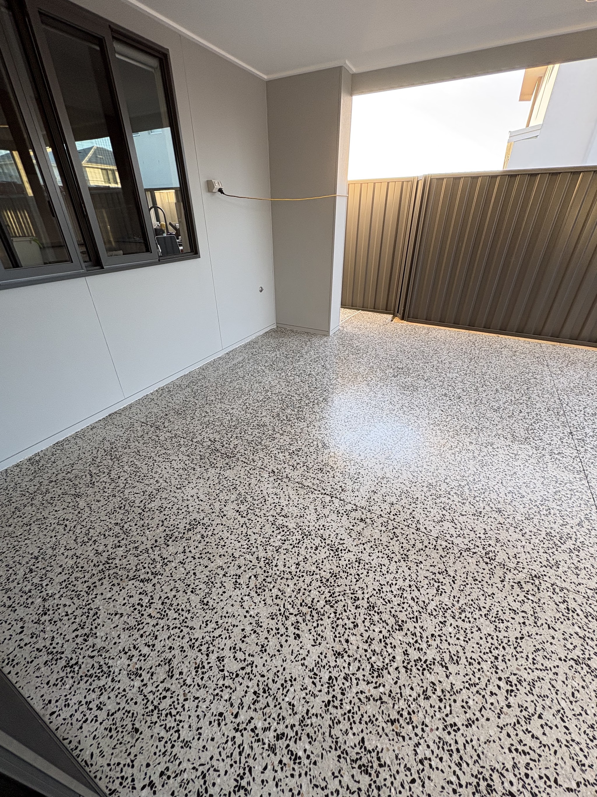 Speckled concrete finish under a covered alfresco